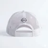 Gorra publicitaria tipo trucker de Nissan Formula E Team, color rosa pastel con diseño de flores de cerezo (Sakura), malla blanca, parche lateral y logotipo central.